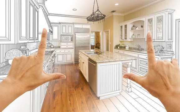 Hands framing a kitchen design concept that blends a pencil sketch with the finished kitchen